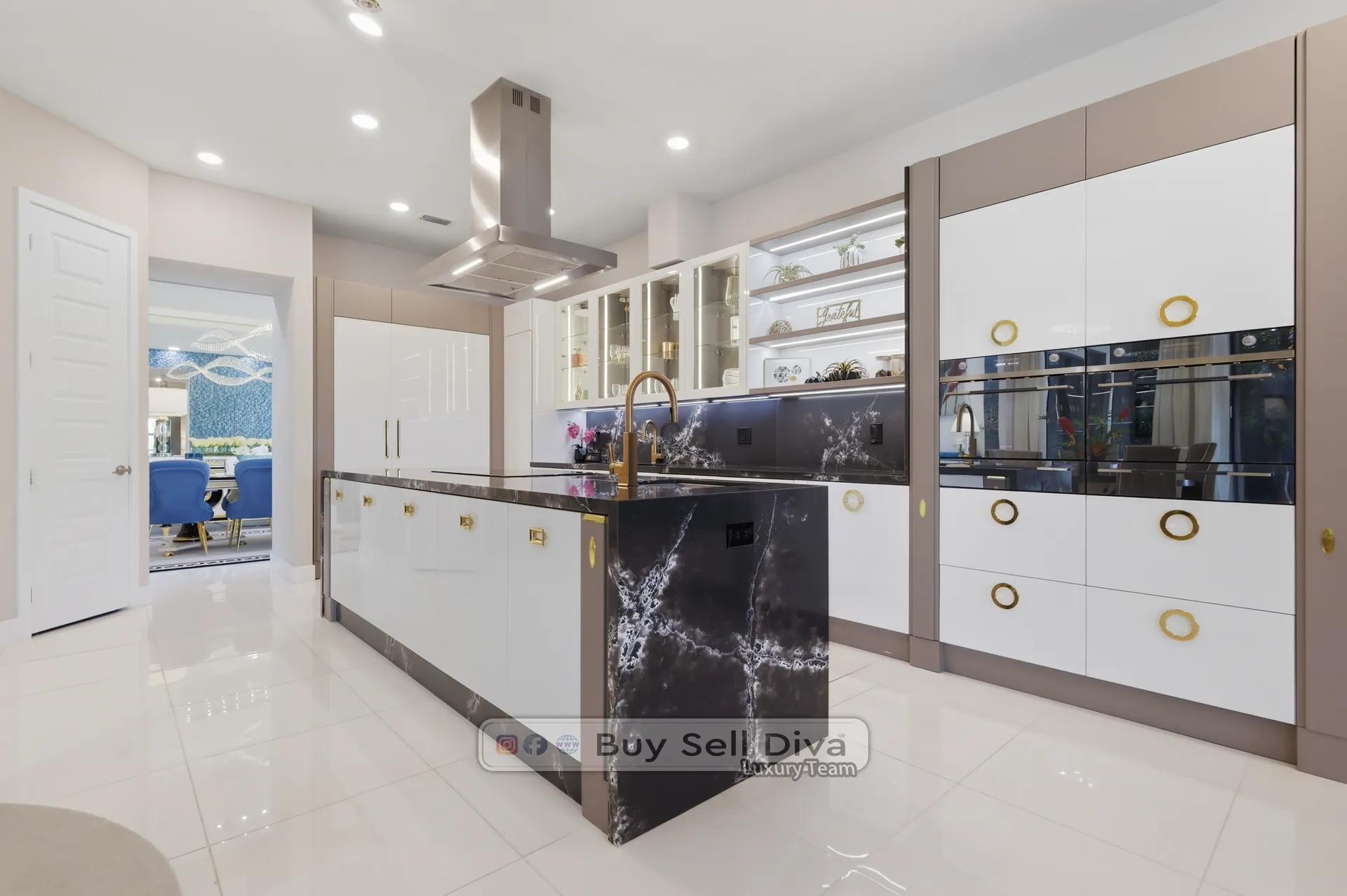 Parkland FL estate home chef's kitchen with quartzite waterfall island, brass hardware, and custom cabinetry