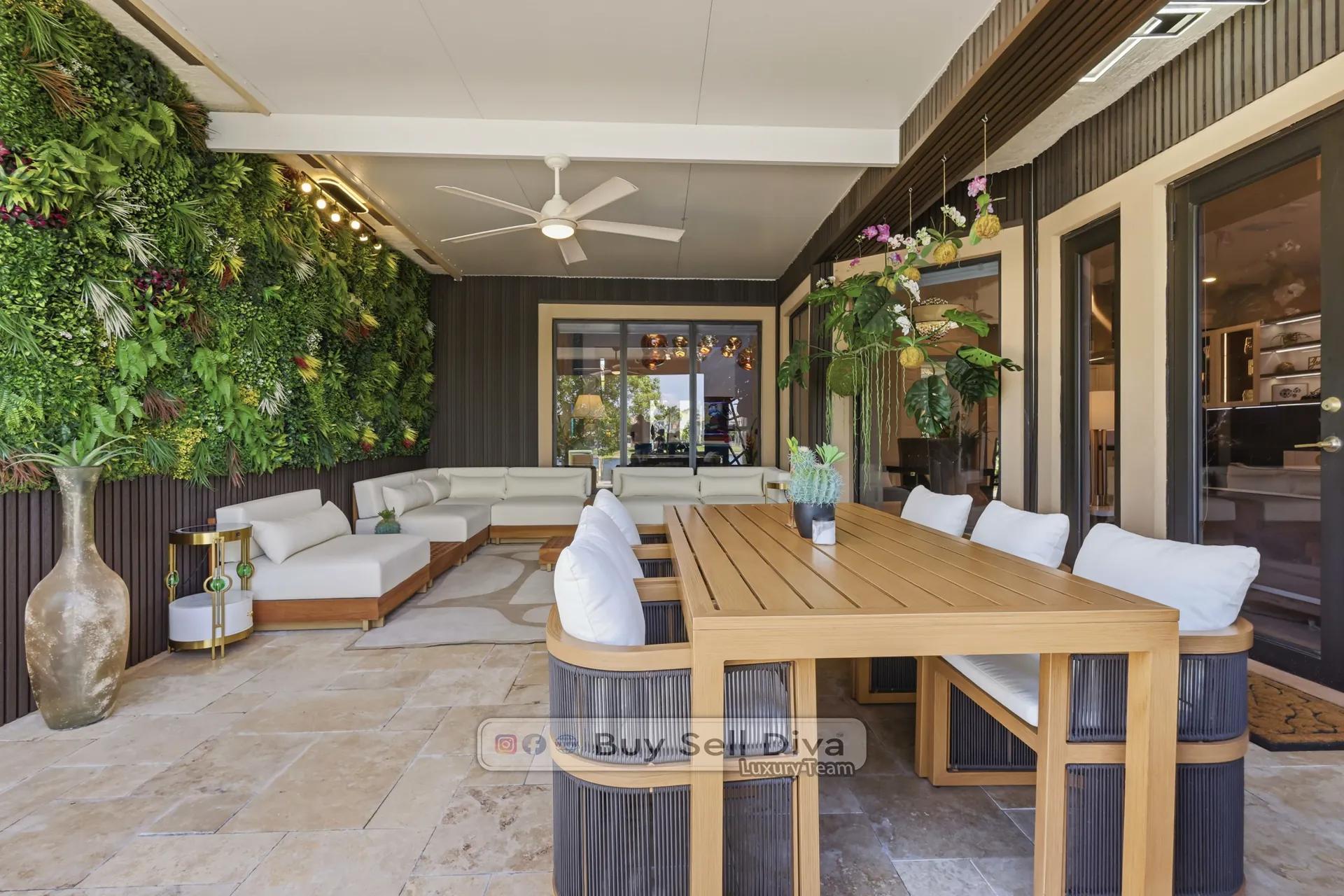 Parkland FL luxury home covered loggia with living plant wall and outdoor dining table
